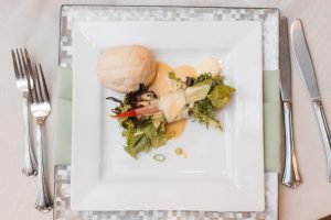 Wedding details featuring a plate with a salad and bread.