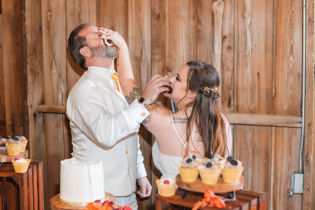 Reception: A bride and groom cutting their wedding cake at the reception.