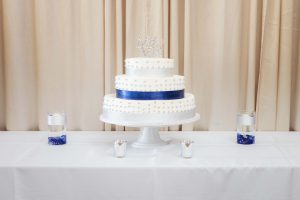 A detailed wedding cake on a table.