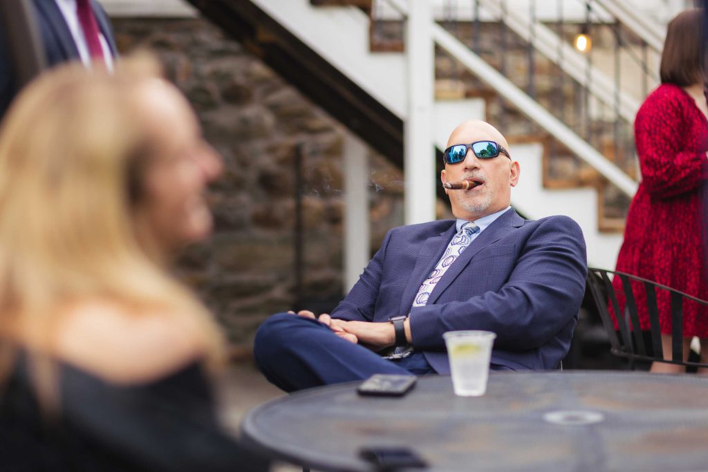 A man in a suit attending a wedding reception.