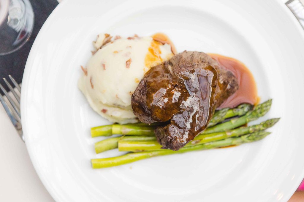 Wedding menu details featuring a plate with steak, asparagus, and mashed potatoes.
