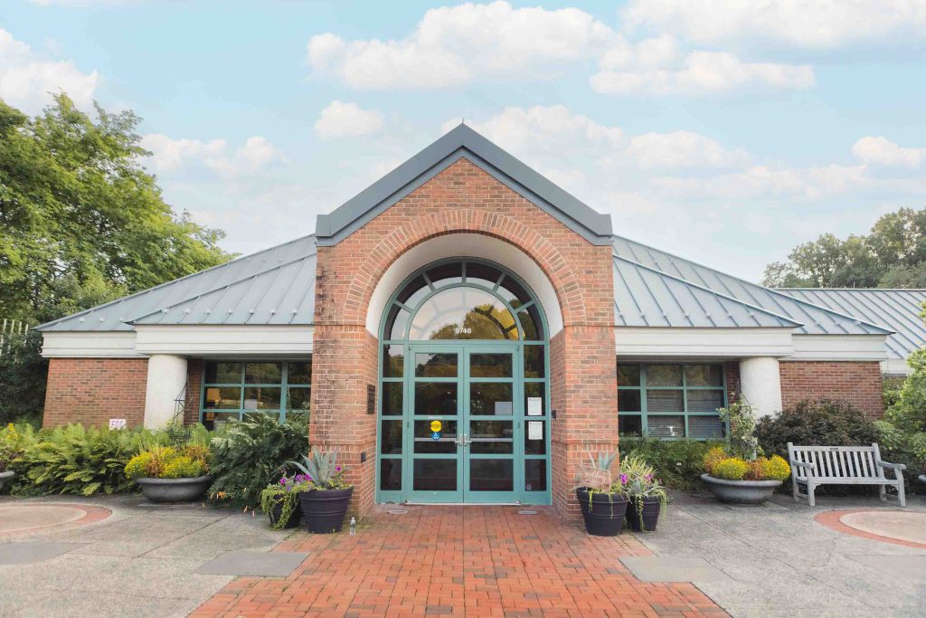 The entrance to a brick building with a green door, emphasizing details.