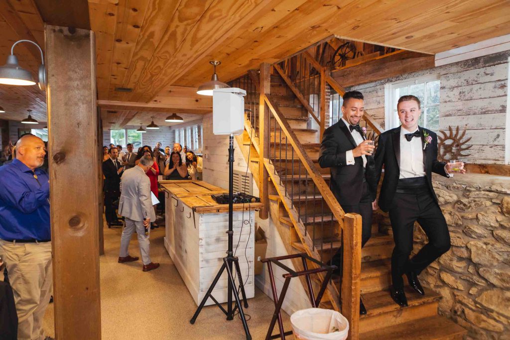 A man in a tuxedo is standing at a wedding reception.
