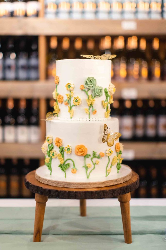 A birthday cake decorated with sunflowers and butterflies.