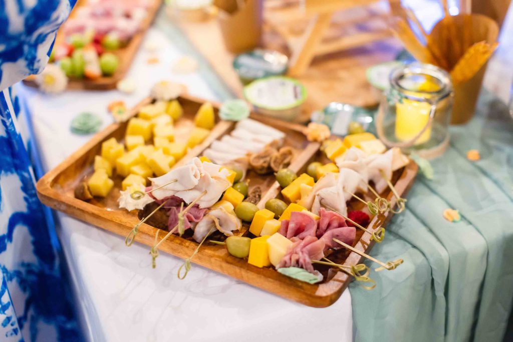 A birthday party or quinceañera with a variety of food on skewers.