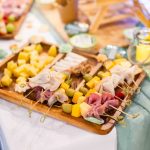 A birthday party or quinceañera with a variety of food on skewers.