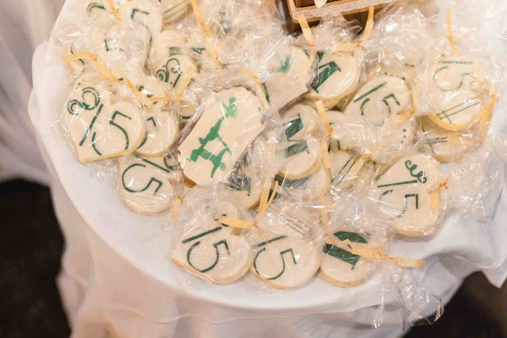 A table full of cookies with numbers on them for a Birthday Party.