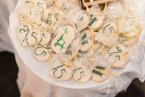 A table full of cookies with numbers on them for a Birthday Party.