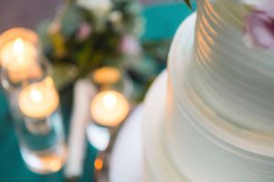 A wedding cake with candles, displaying intricate details.