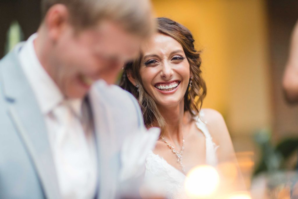 A wedding reception where the bride and groom share a smile.