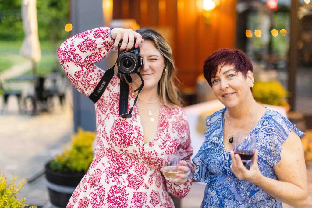 Two women taking a picture at a quinceanera.