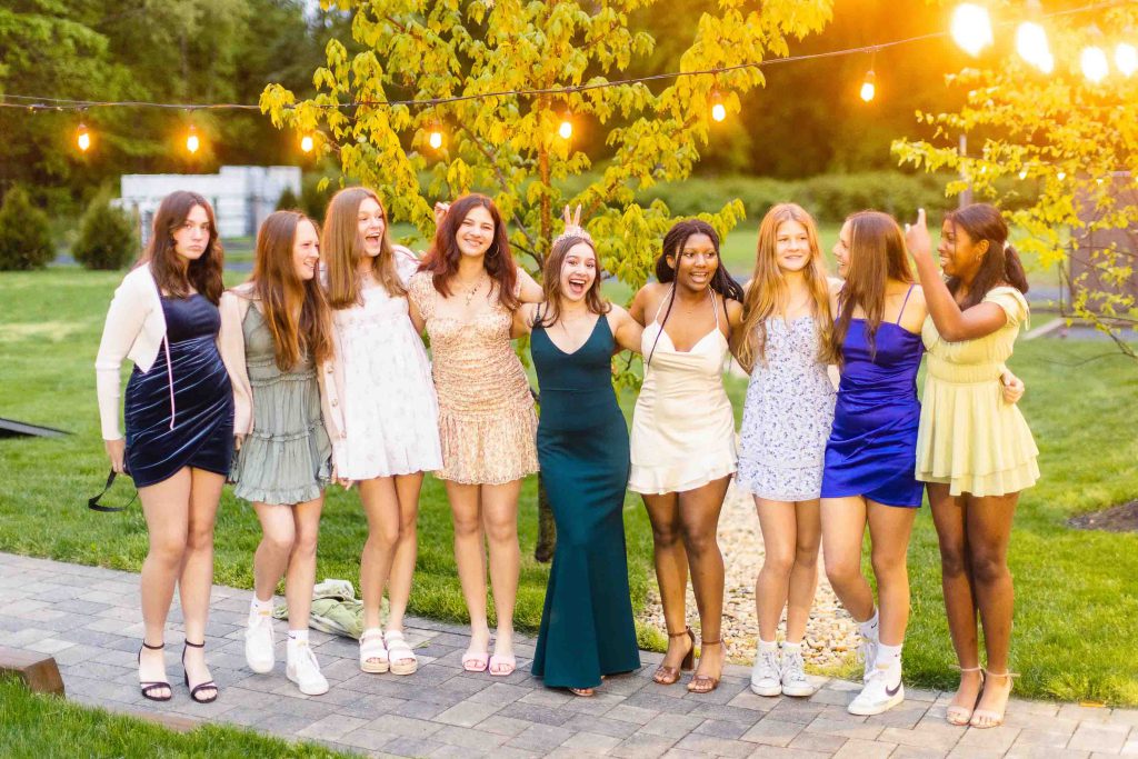 A group of girls in dresses posing for a quinceanera photo.