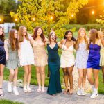 A group of girls in dresses posing for a quinceanera photo.
