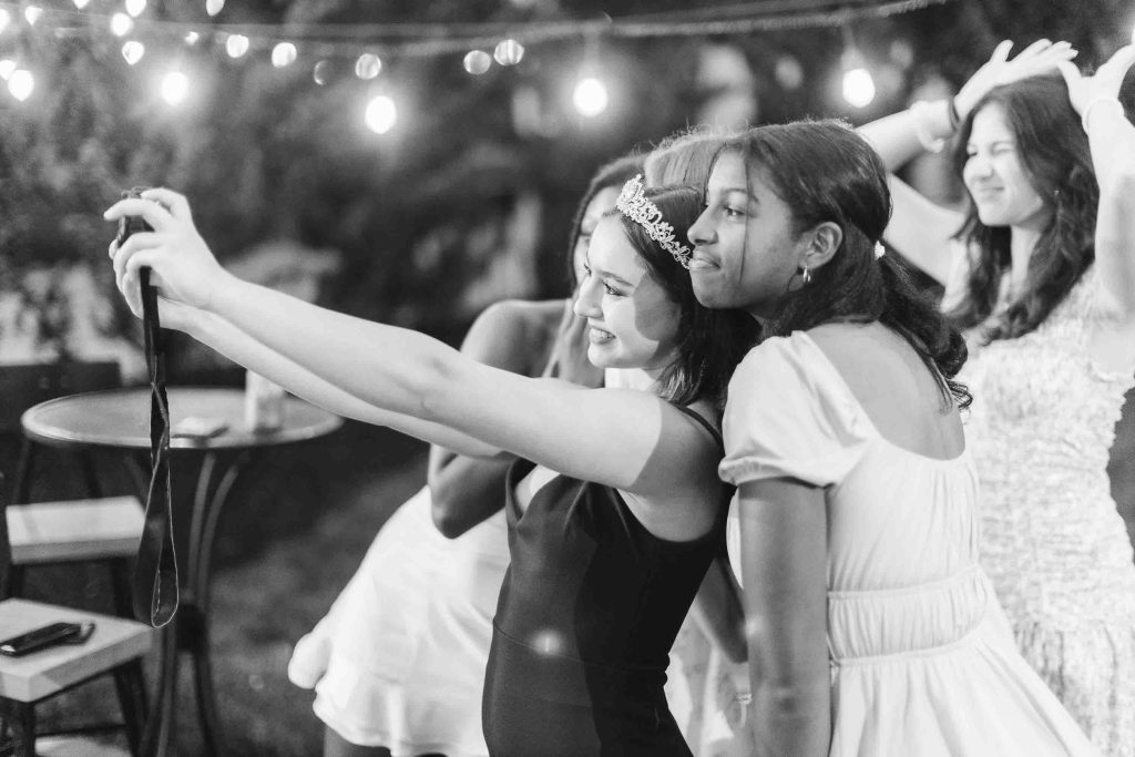 A group of girls taking a selfie at a quinceañera party.