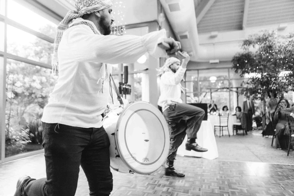 Two men playing drums at a wedding reception.