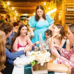 A group of people celebrating a quinceañera at a restaurant.