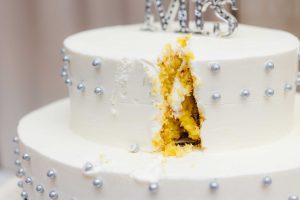 A detailed wedding cake with the word mrs written on it.