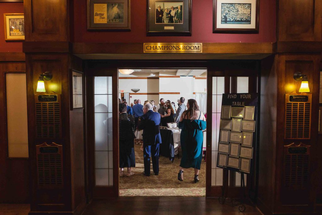 A group of people standing in the doorway of a wedding building.