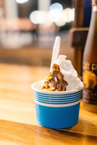 A bowl of ice cream on a table at a Birthday Party.