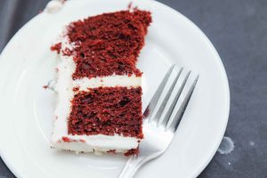 A slice of red velvet cake on a plate.