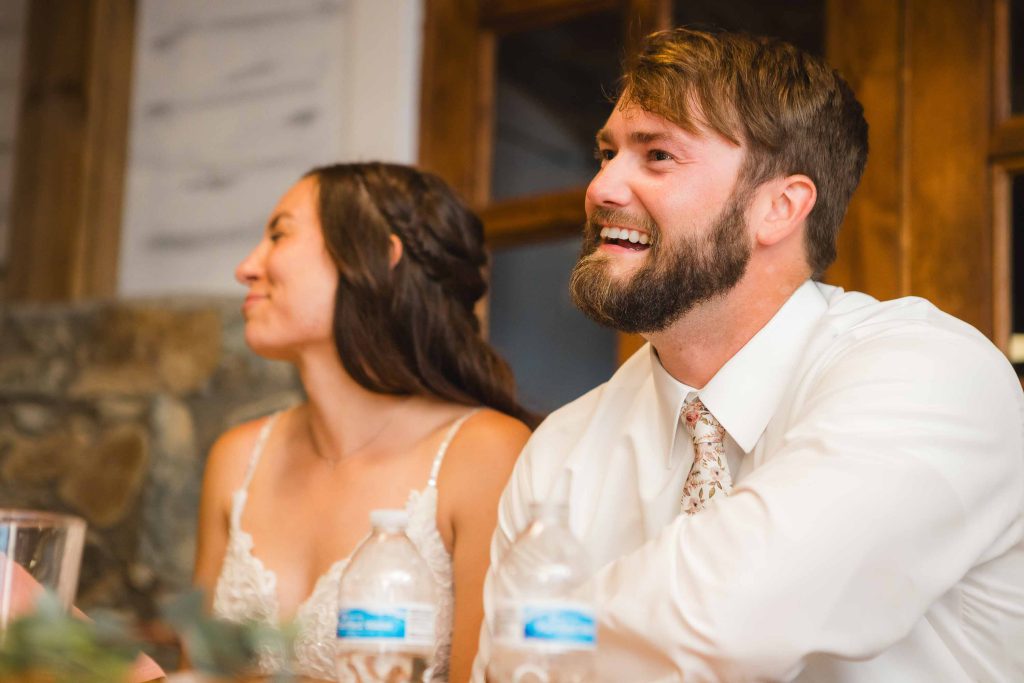 A couple happily exchanging vows at their wedding reception.