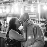 A couple kissing at a Birthday Party.