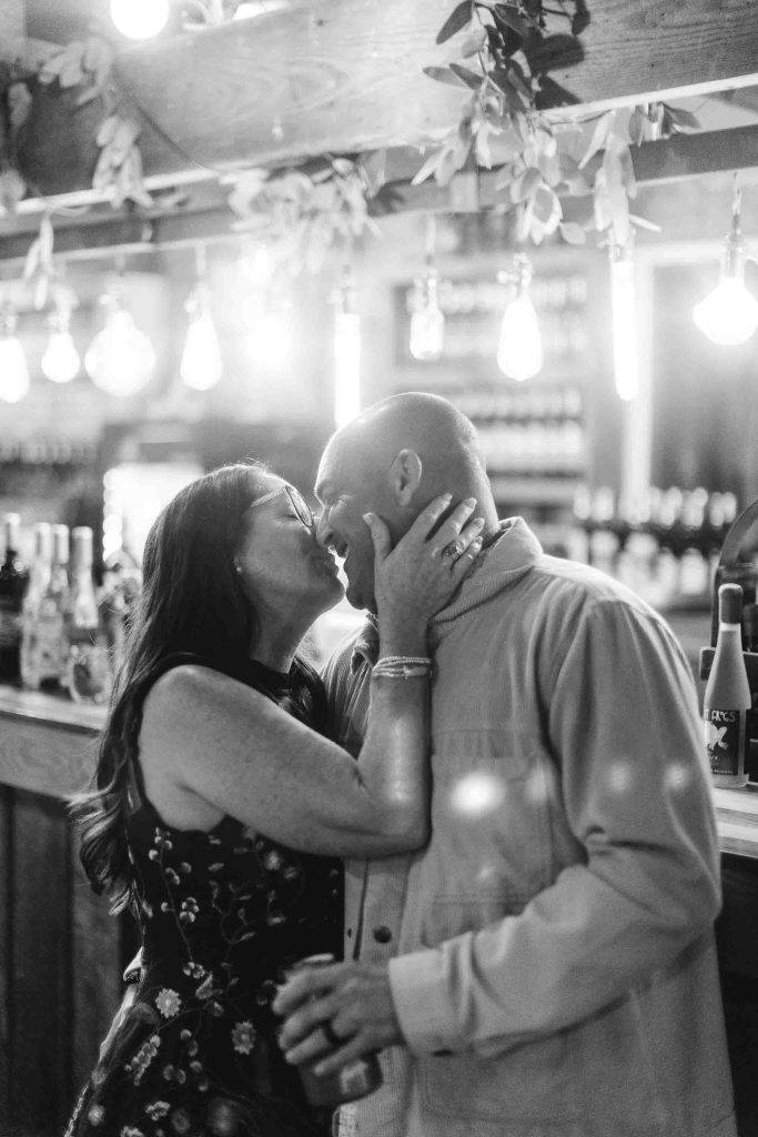 A couple kissing at a Birthday Party.