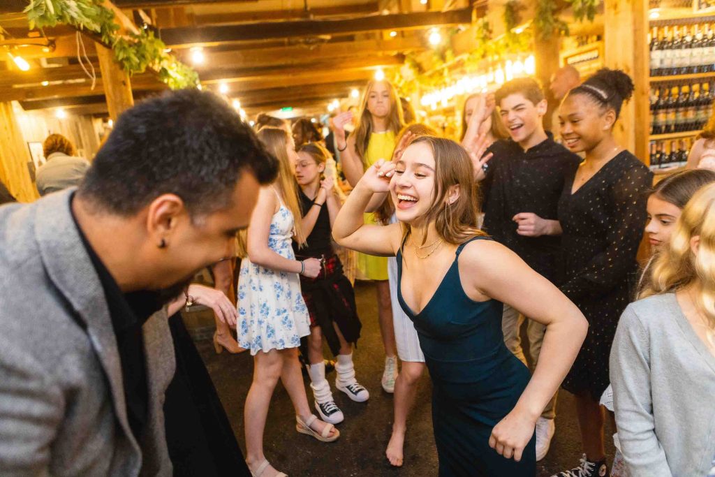 A group of people dancing at a quinceanera.