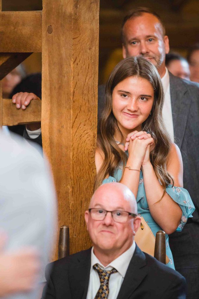 A bride and groom exchanging glances during their wedding ceremony.