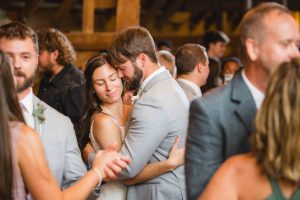 A bride and groom embracing at their wedding reception.