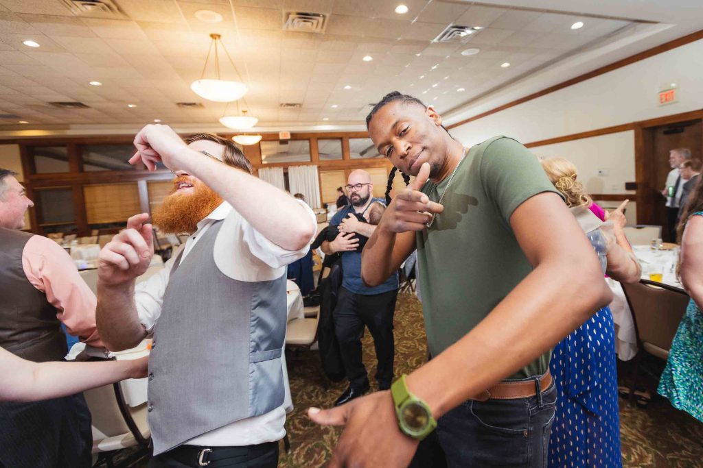 A group of people dancing at a wedding reception.