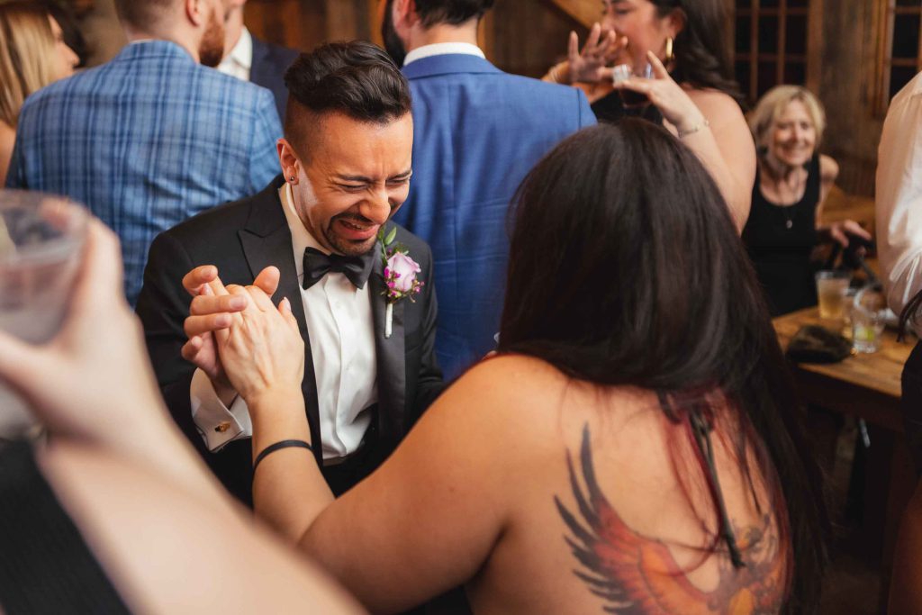 A man dancing at a wedding reception.