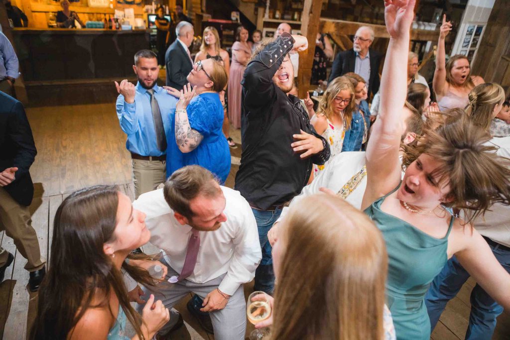A group of people dancing at a reception.