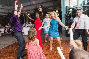 A group of people celebrating at a wedding reception.