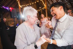 A couple dancing at their barn wedding reception.
