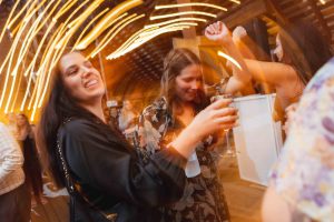 A group of people having fun at a wedding reception.