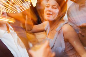 A group of people having a good time at a wedding reception.