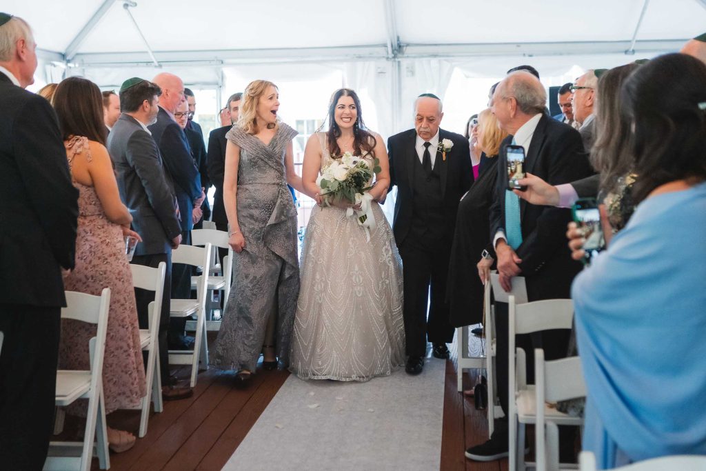 Description: A bride and groom having their wedding ceremony in a tent at Savage Mill.