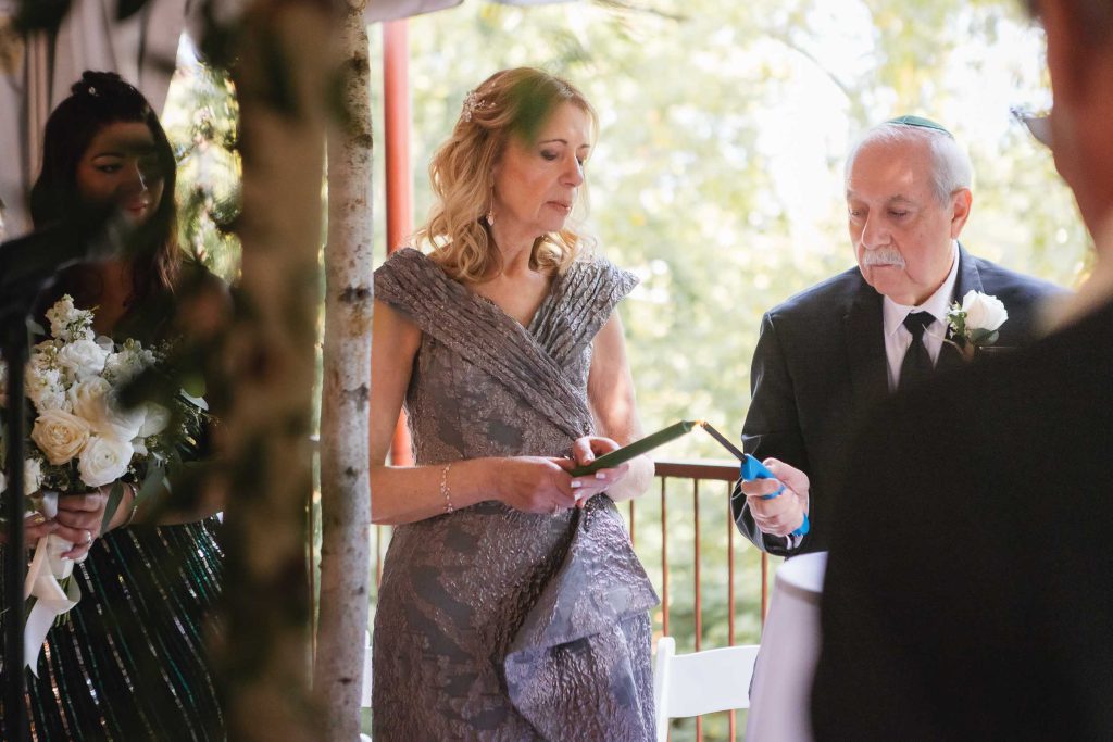 A man is reading wedding vows during a ceremony at Savage Mill.