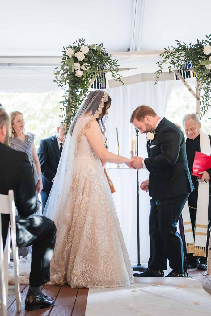 A couple at Savage Mill exchange rings during their wedding ceremony.
