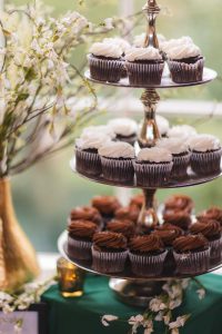 Wedding chocolate cupcakes beautifully displayed on a three-tiered stand at Savage Mill, showcasing intricate details.