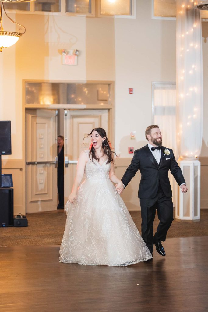 A bride and groom dancing on the dance floor at their wedding reception at Savage Mill.