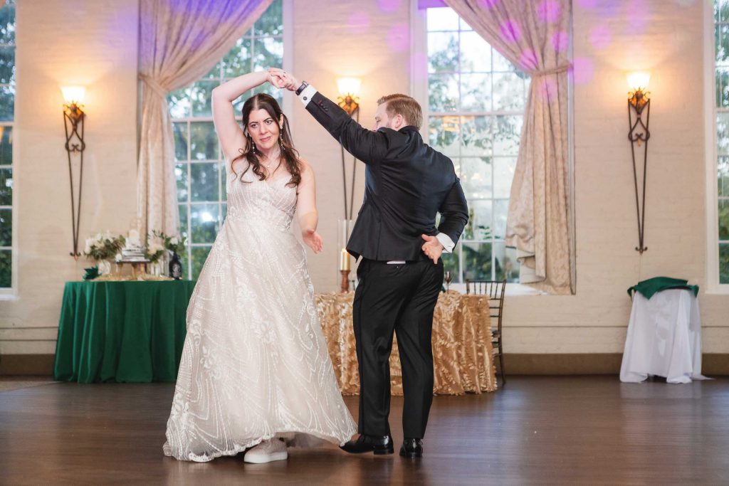 A bride and groom sharing their first dance at a wedding reception.