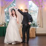 A bride and groom sharing their first dance at a wedding reception.