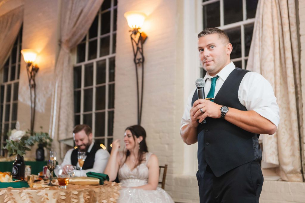 The groom delivering a heartfelt speech at a wedding reception.