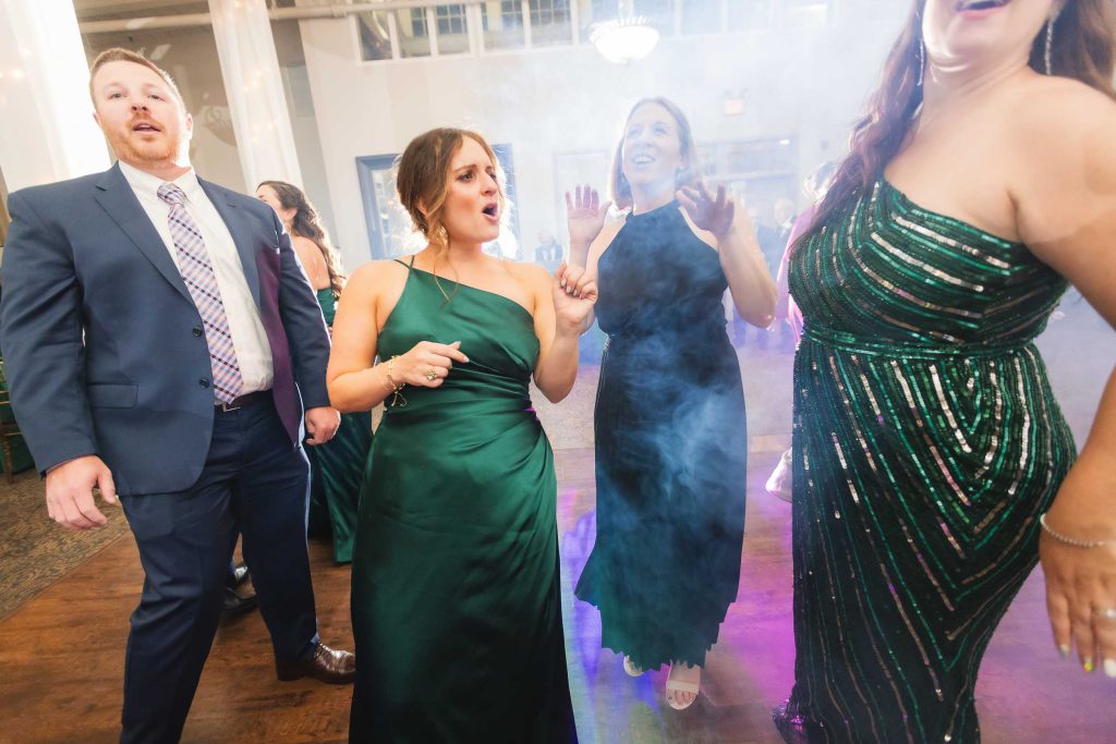 A group of bridesmaids dancing at a wedding reception.