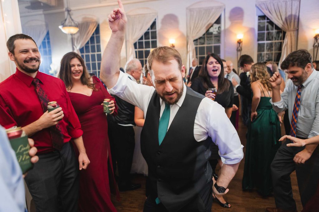 A man is dancing at a wedding reception held at Savage Mill.