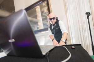 A man wearing sunglasses at a wedding reception in Savage Mill.