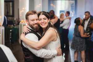 A bride and groom embracing during their wedding reception at Savage Mill.