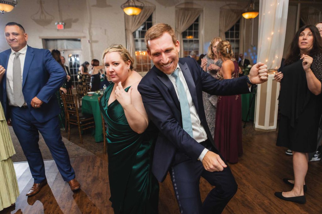 A man and woman gracefully dancing at a wedding reception held at Savage Mill.